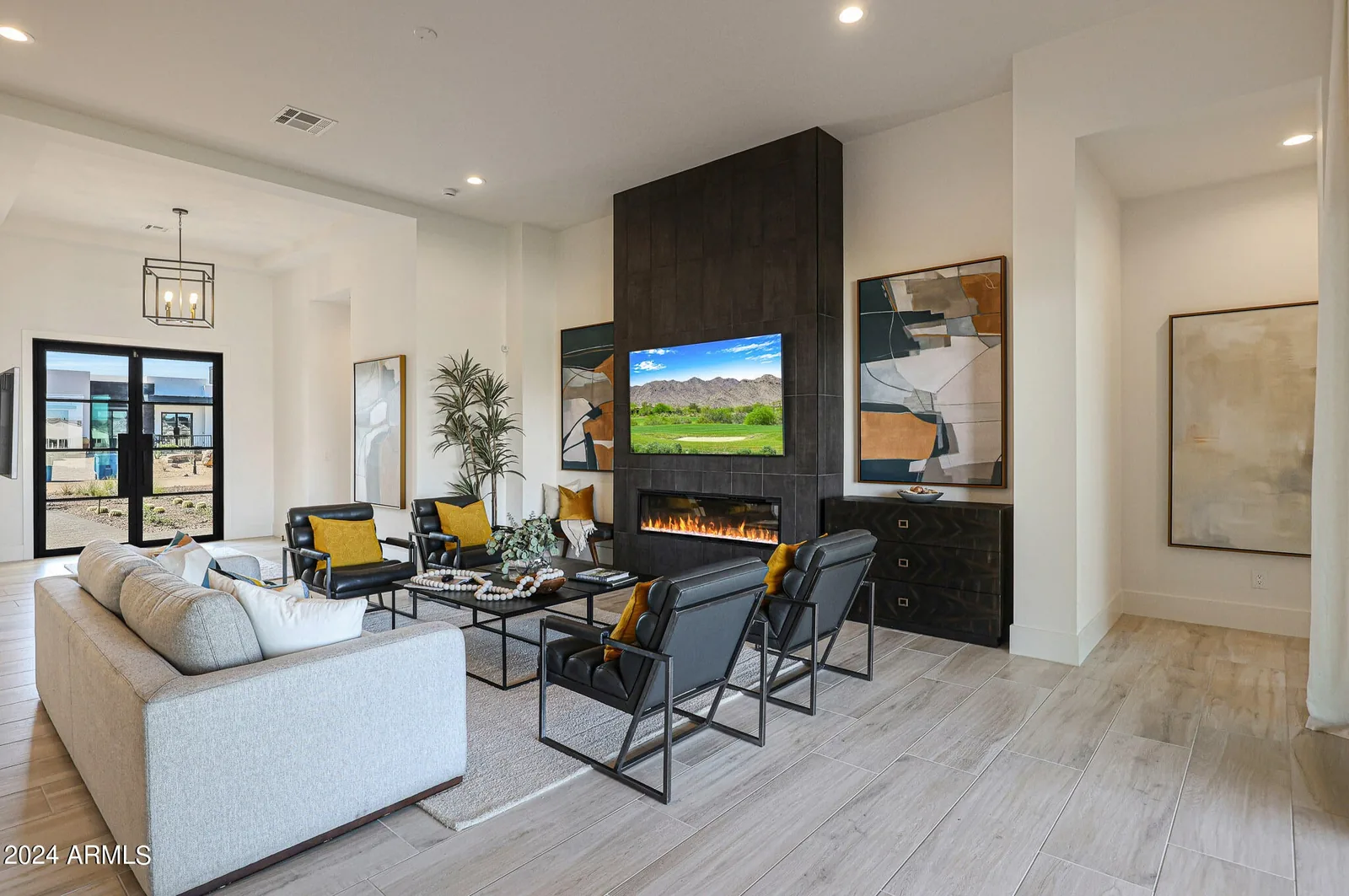 Bright living room with a fireplace, contemporary seating, and patio doors