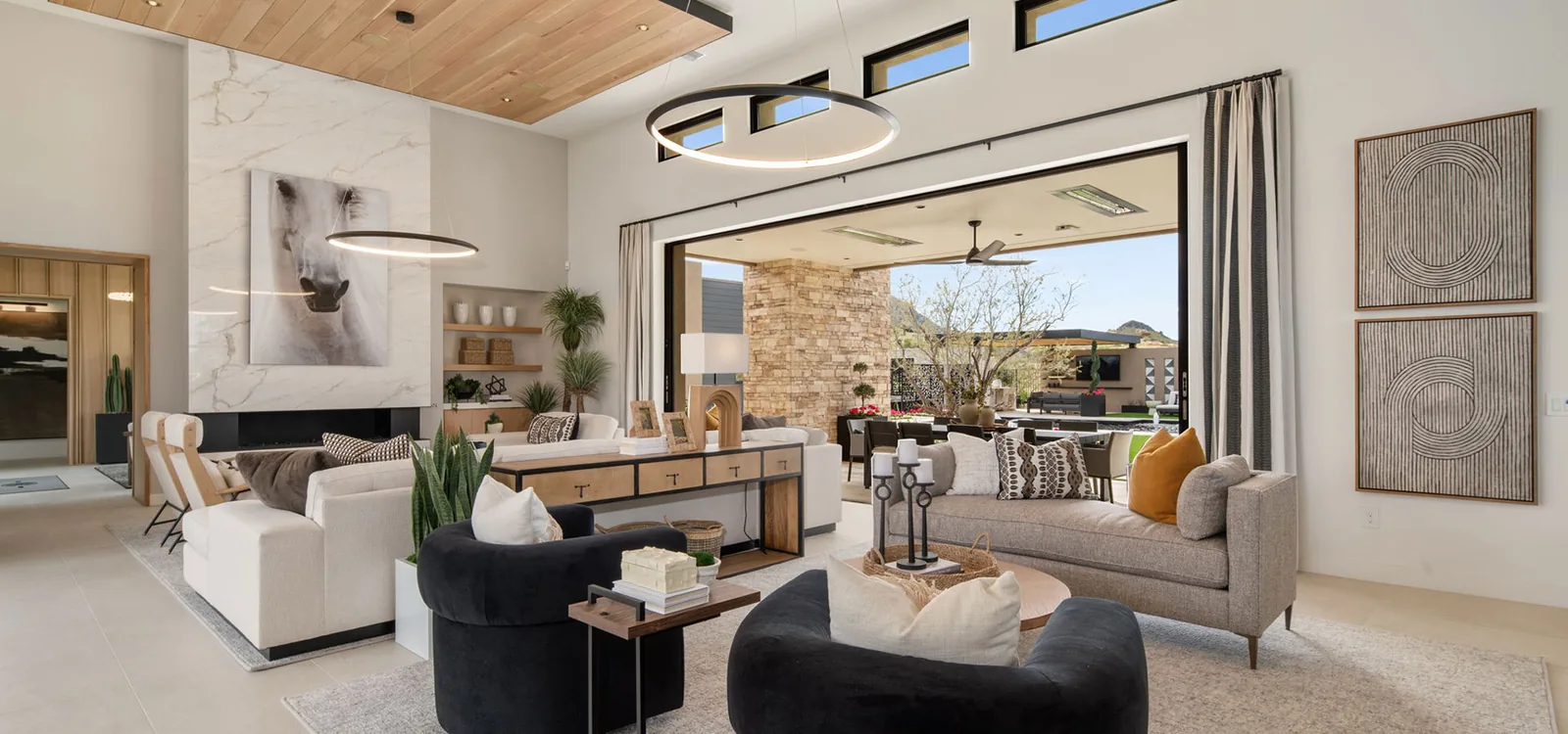 Open-plan living room with a wood ceiling and an outdoor entertaining area